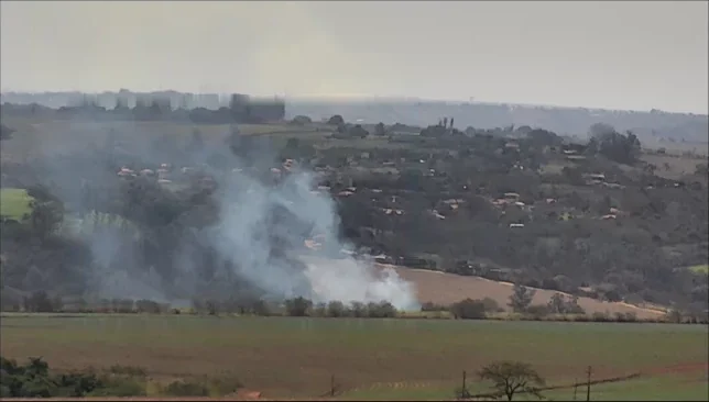 Wildfire smoke rising over farmland, detected and boxed by the Pantera camera network.
