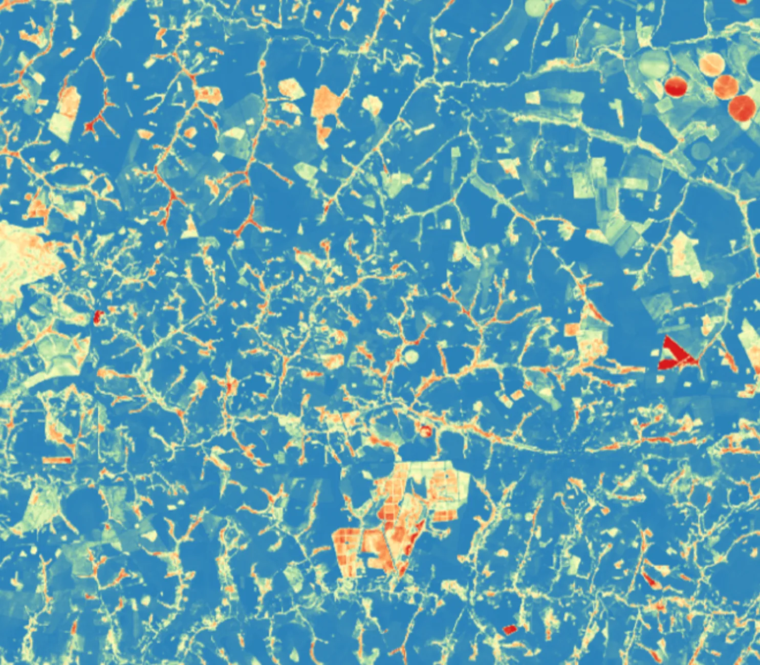Fire-risk map of a rural area: field plots and drainage lines colored from blue, lower risk, to red, higher risk.